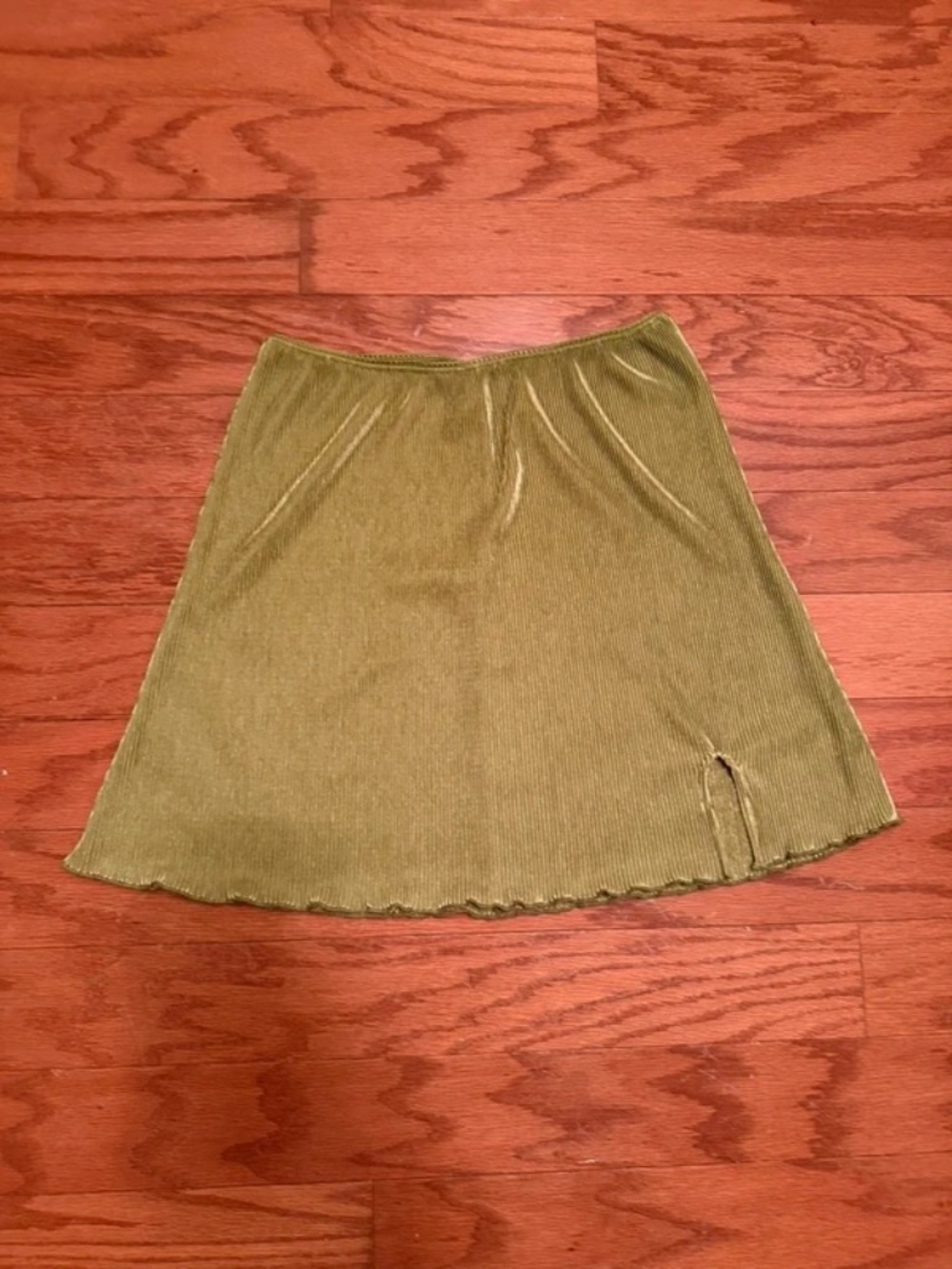 Olive green mini skirt in a soft ribbed velvet/velour fabric with a subtle sheen